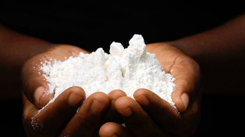 Closeup of an African woman´s hands holding maize flour.